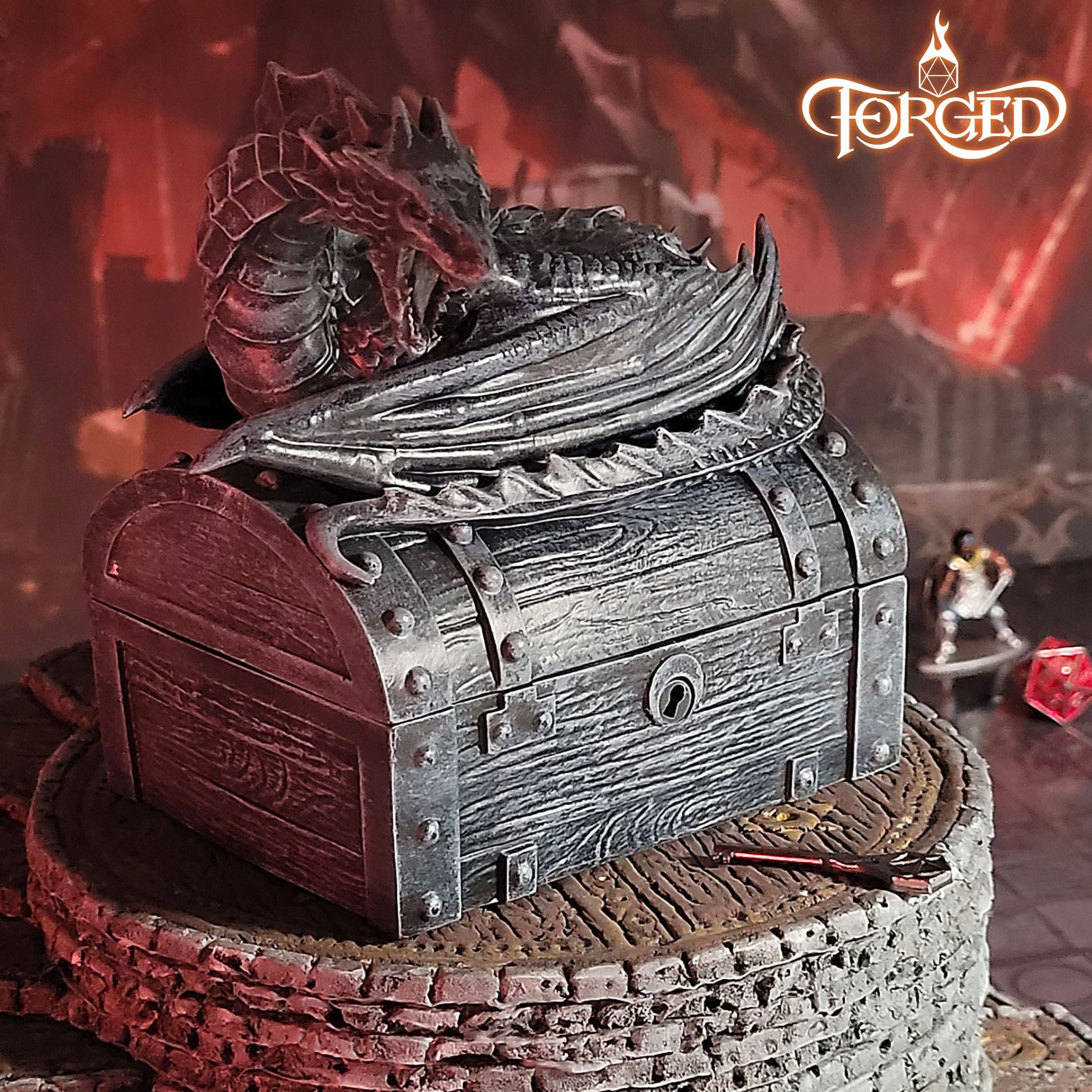 This is an environmental image of the Stone colored Forged Gaming Wyvern Dice Chest sitting on a piece of gaming terrain.