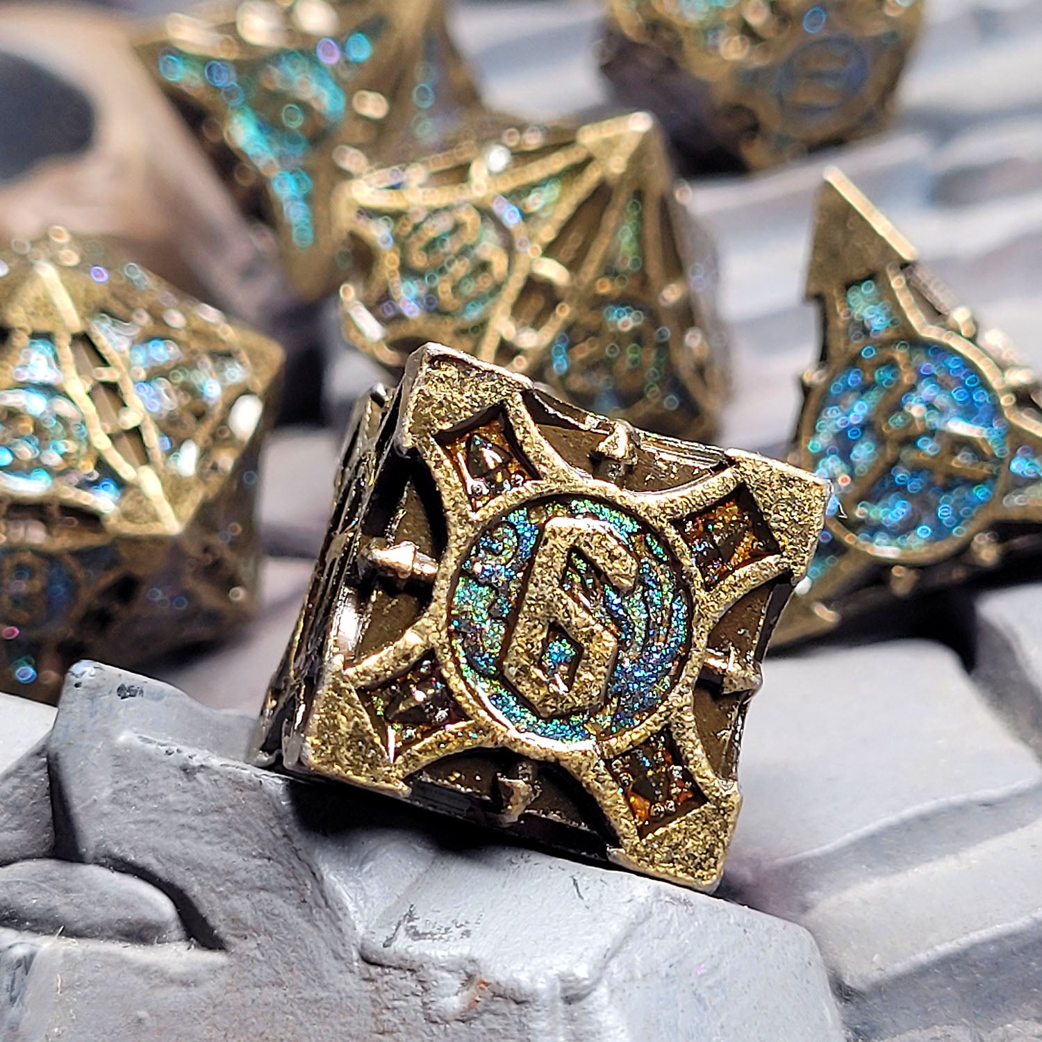 This is an environmental image of the Forged Gaming Arcane Enigma Metal RPG Dice Set. The photo was taken using a piece of wargaming terrain as a background.