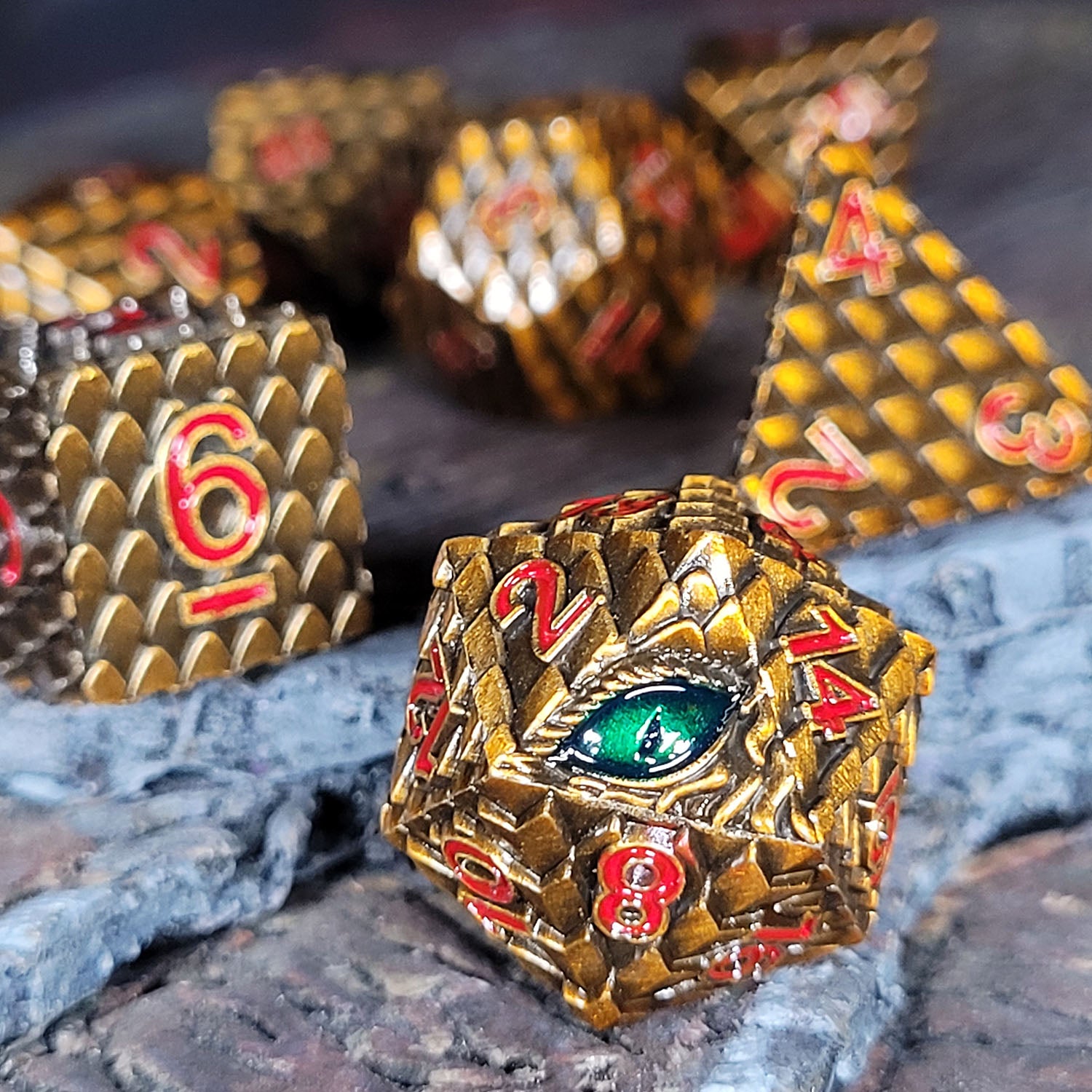 This is an environmental image of the Forged Gaming Dragon's Gaze Bronze Metal Dice Set. This photo was taken using a piece of temple ruins wargaming terrain as a background.