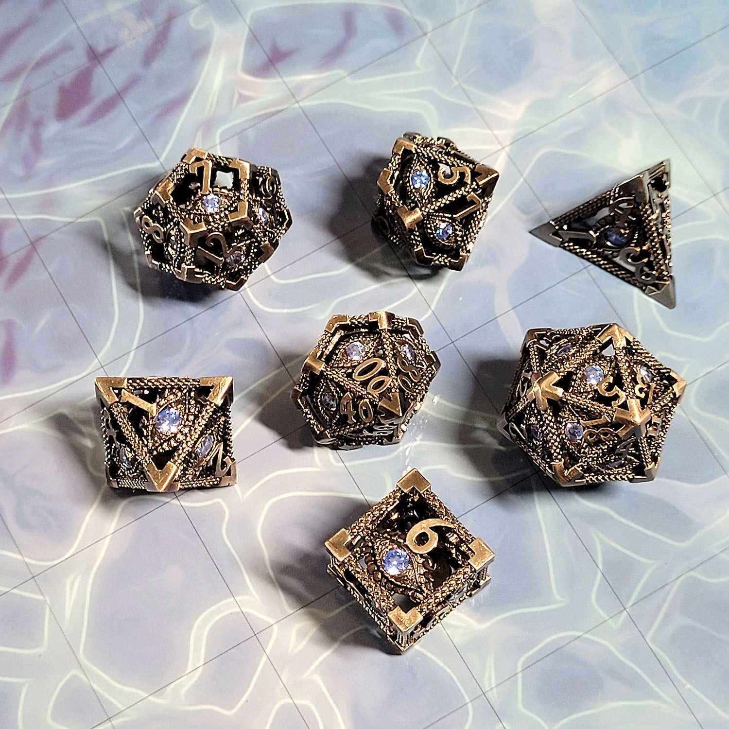 This is an environmental image of the Forged Gaming Serpent's Eye Silver Hollow Metal RPG Dice Set. The photo was taken using the Open Water Encounter Map as a background.