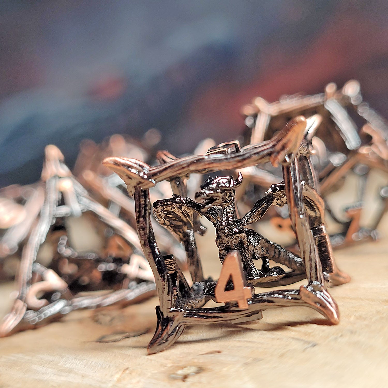 This is an environmental image of the Forged Gaming Wicker Dragon Copper Hollow Metal RPG Dice Set. The photo was taken using a piece of wood as a background.