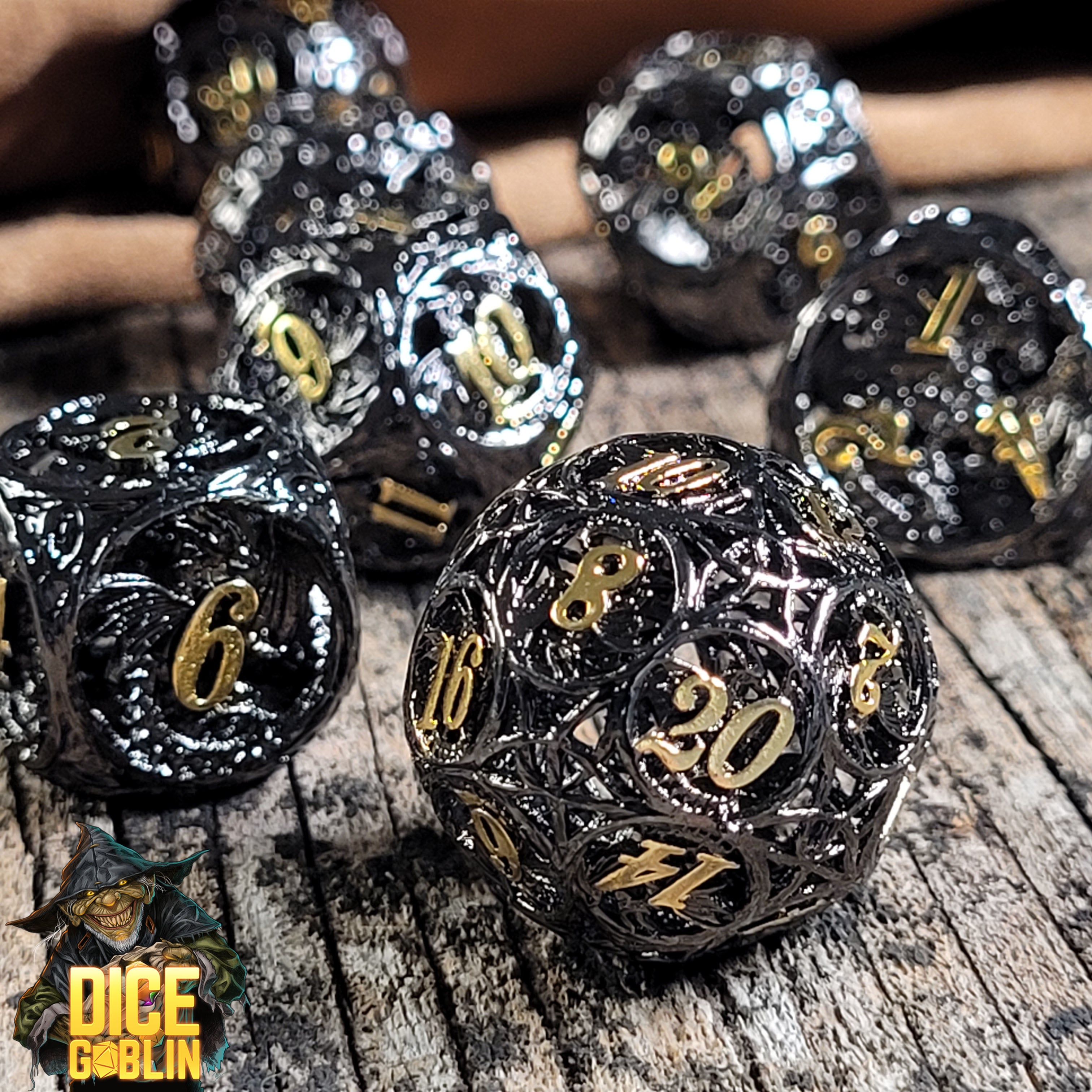 This is an environmental image of the Dice Goblin Dragon's Round Black with Gold  Metal RPG Dice Set on a distressed wood surface.