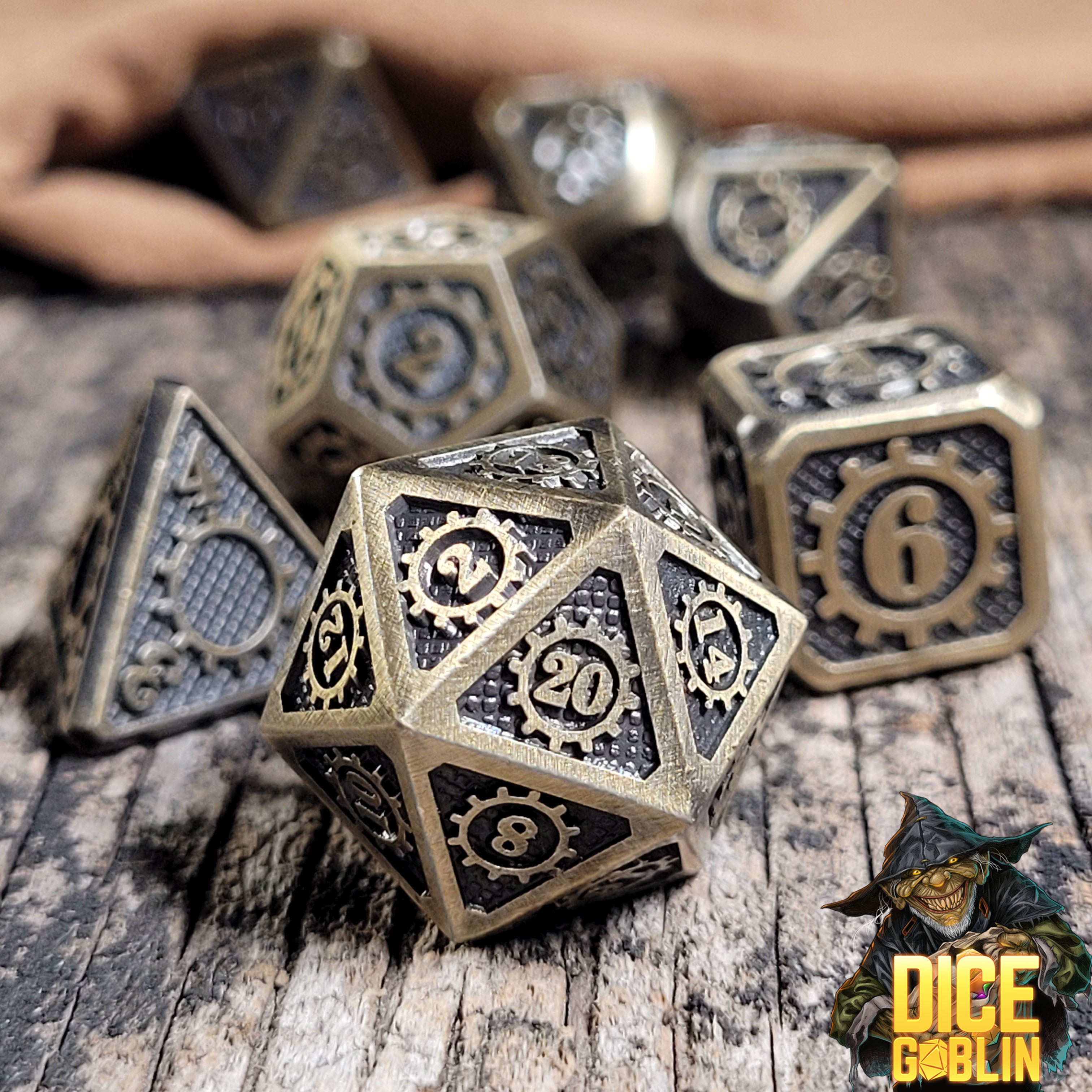 This is an environmental image of the Dice Goblin Gears Weathered Gold Metal RPG Dice Set on a distressed wood surface.