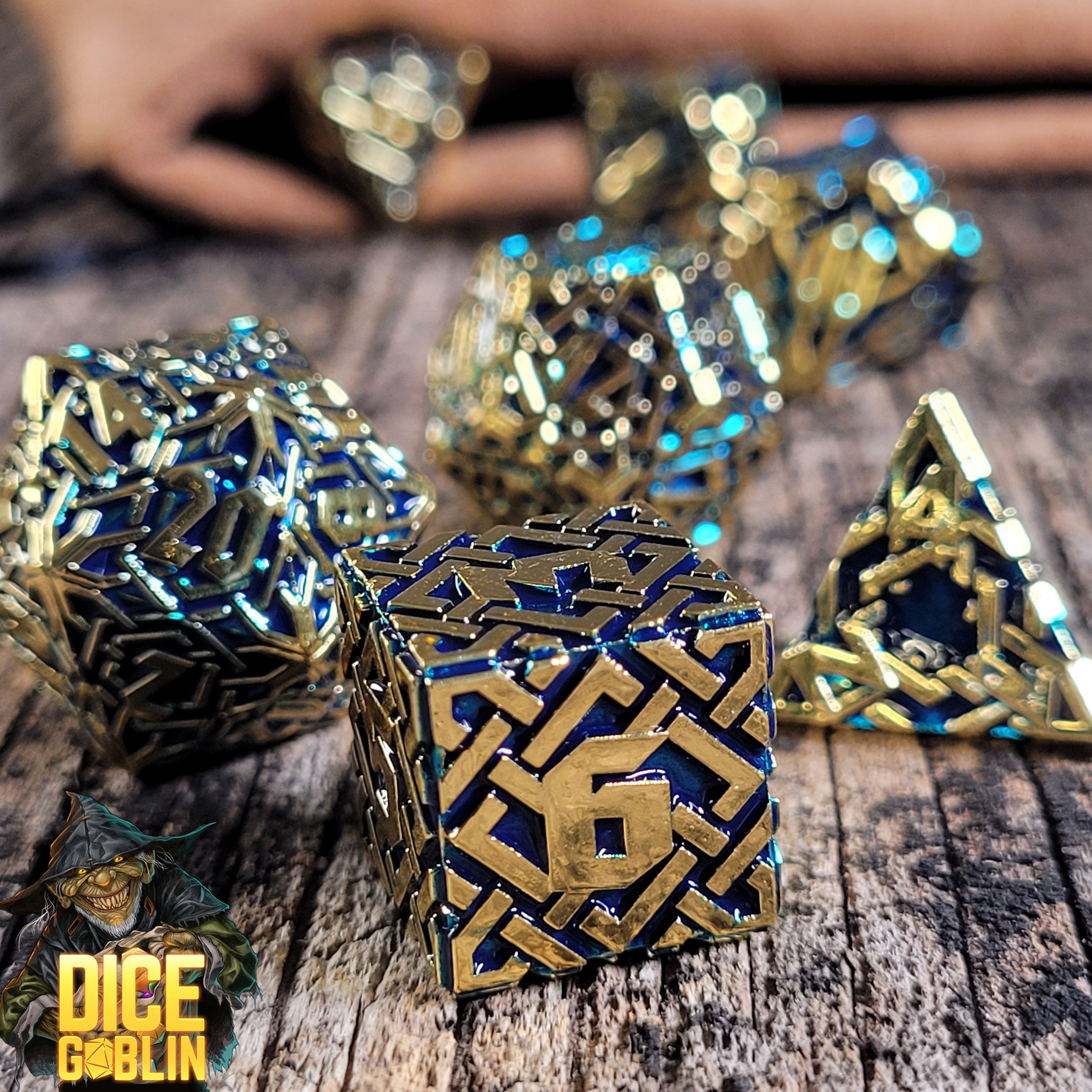 This is an environmental image of the Dice Goblin Knots Gold with Blue Metal RPG Dice Set on a distressed wood surface.