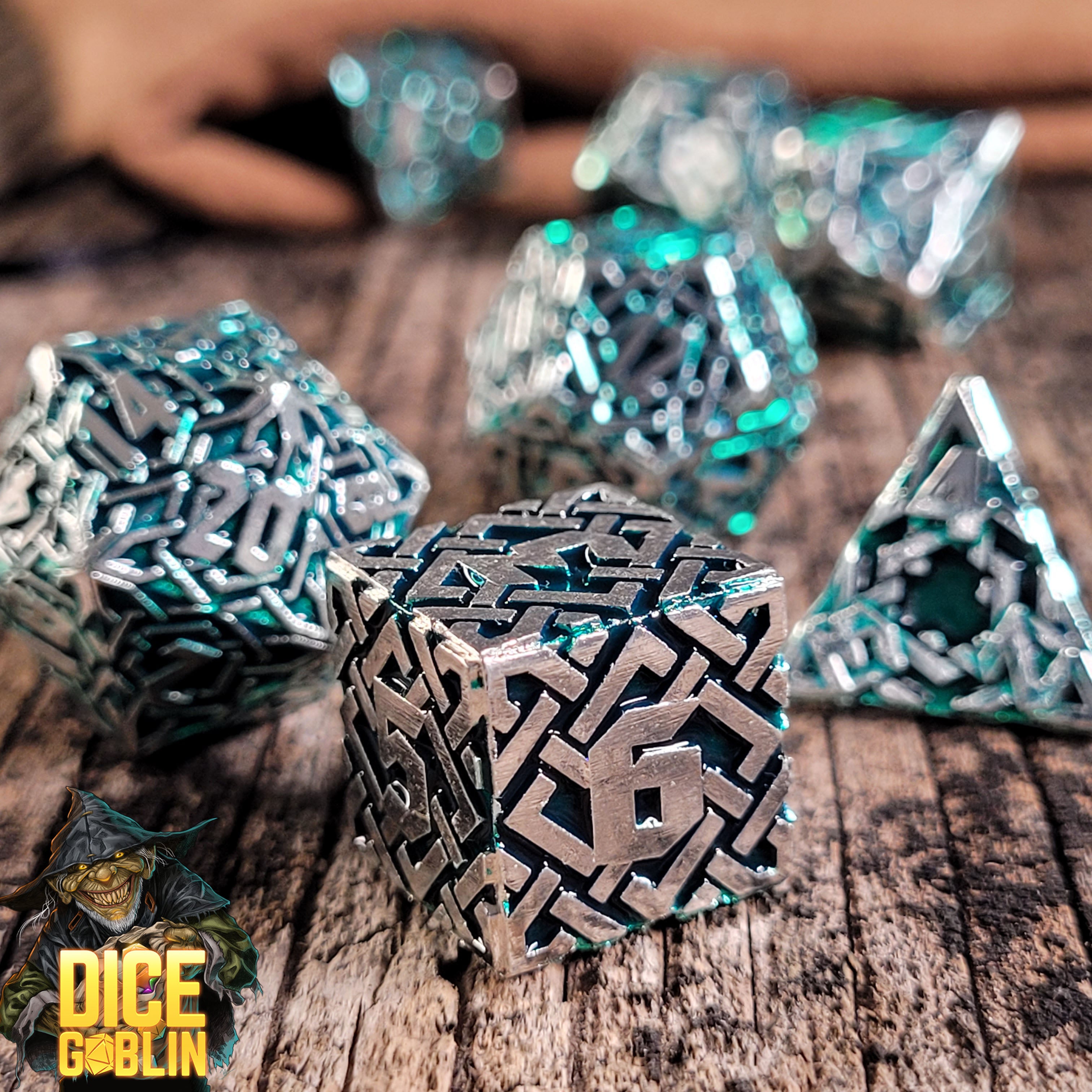 This is an environmental image of the Dice Goblin Knots Gold with Green Metal RPG Dice Set on a distressed wood surface.