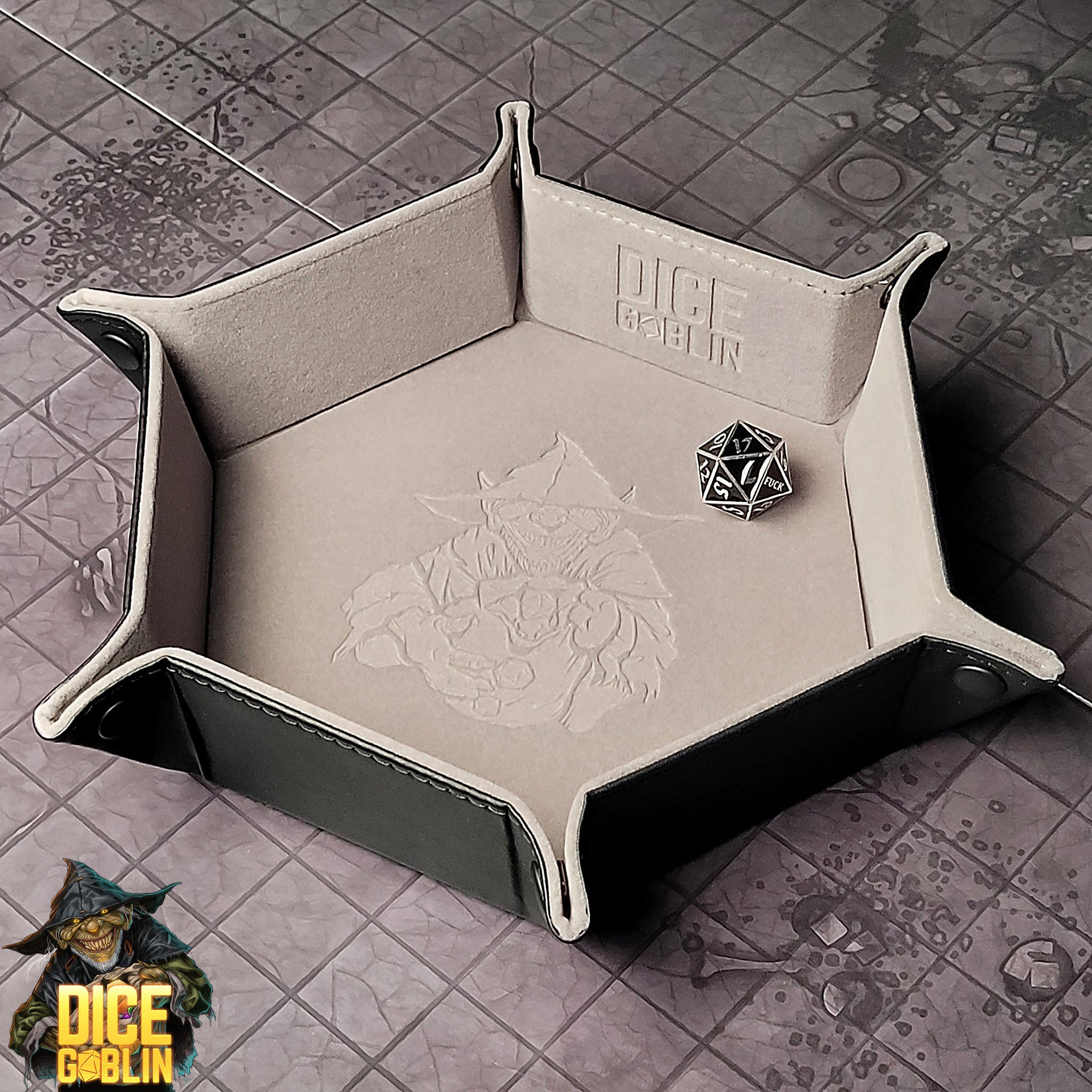 This is an environmental image of the Gray colored Dice Goblin Hexagon folding Snap Dice Tray with a dungeon encounter map as a background.