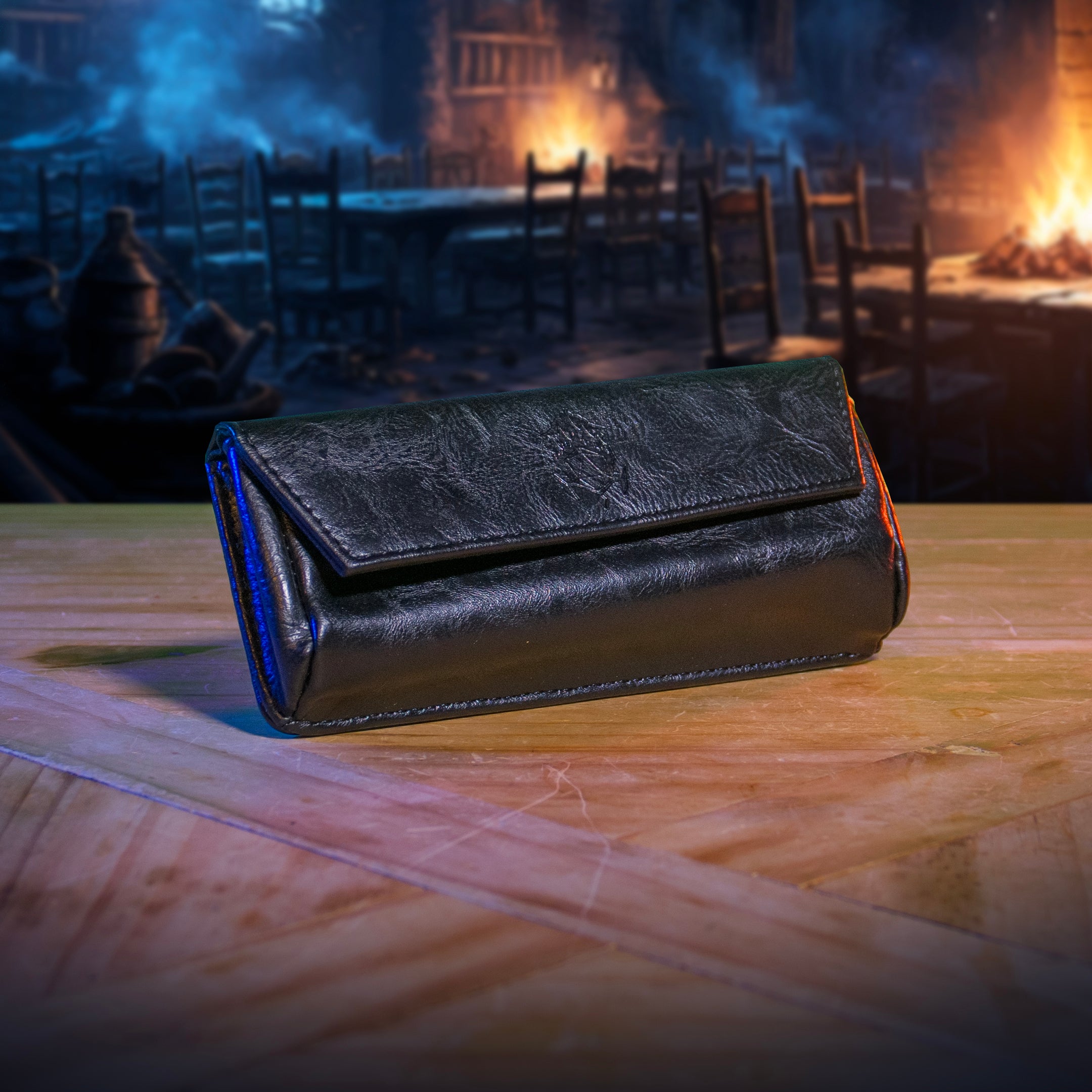 This is an environmental image of he black version of the Ultimate Game Master Screen Large Pouch displayed on a table.