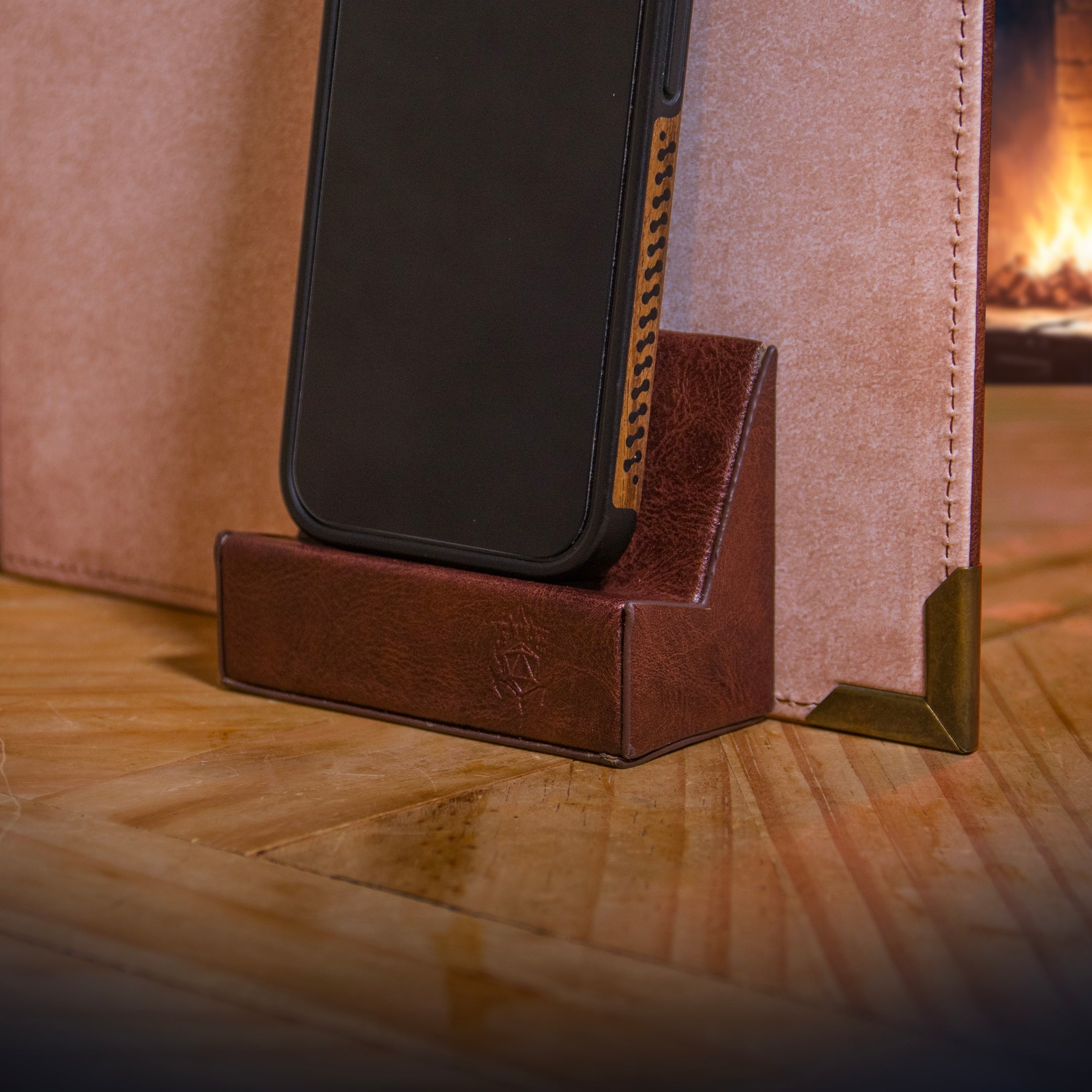This is an environmental image of the brown version Ultimate Game Master Screen Phone Holder in use.