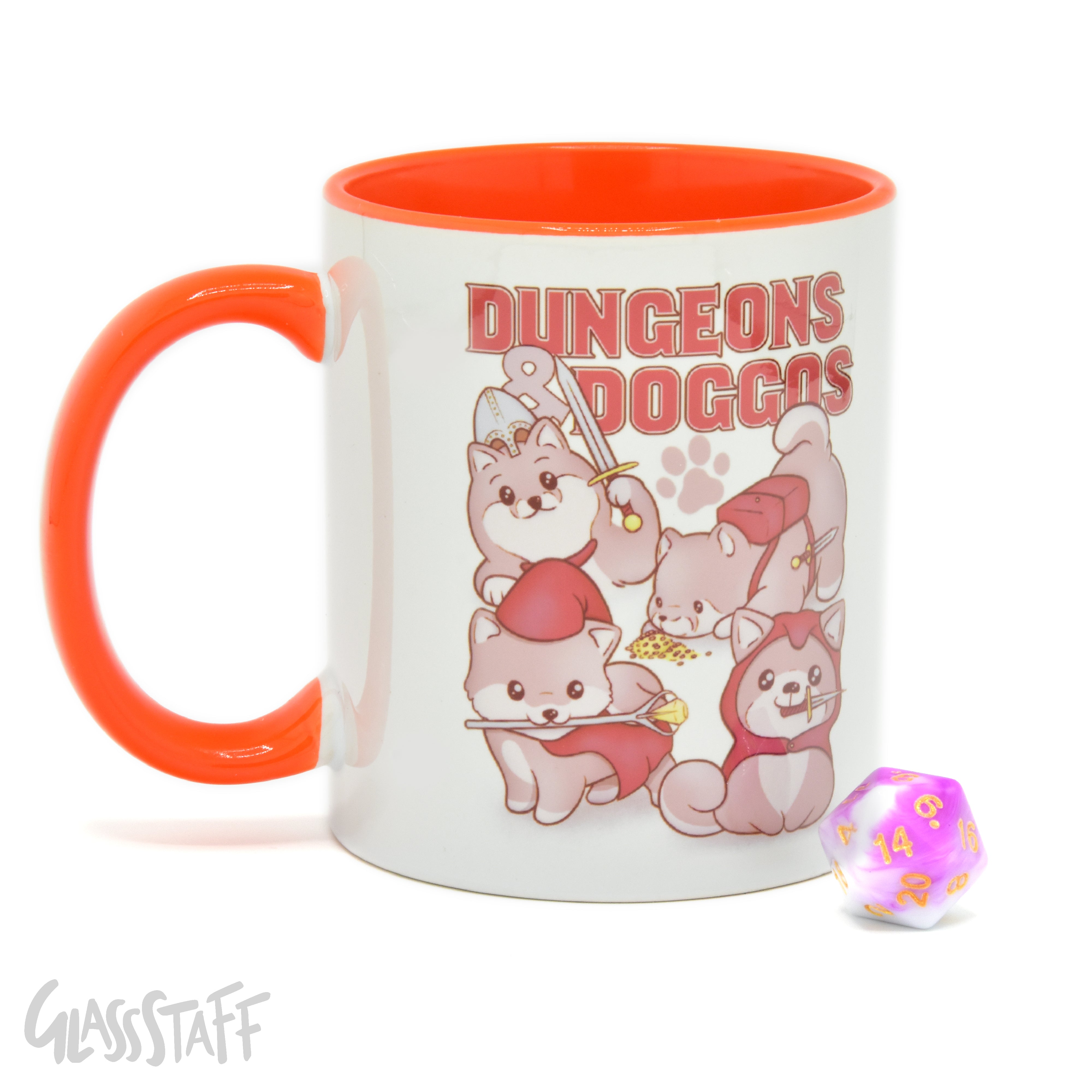 This is a white background image of the GLassStaff Dungeons and Doggos ceramic mug. It shows the white mug with an orange handle, orange inside, and Dungeons and Doggos design. It also shows the D20 die included with the mug.